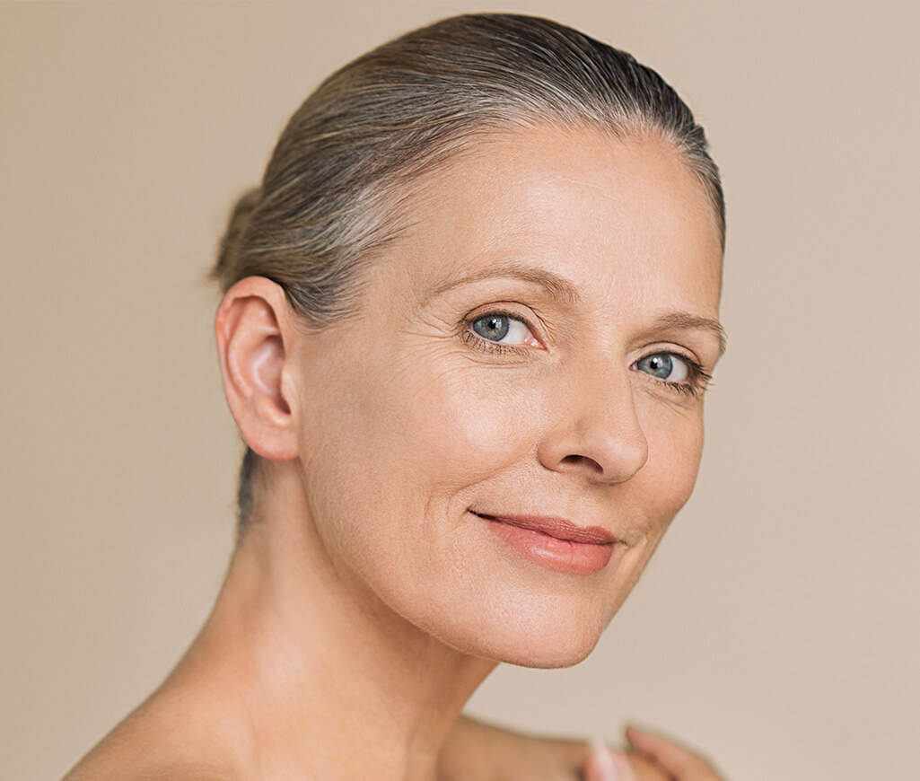 older woman smiling with even, healthy skin